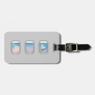 flying pig through airplane window luggage tag