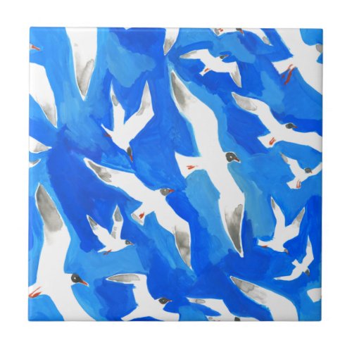 Flying seagulls on sky blue ceramic tile