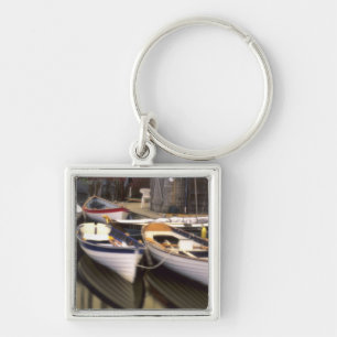 Fog surrounds four boats docked. keychain