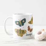 Folk Art Moths Butterflies Collage Personalized Coffee Mug<br><div class="desc">This mug features a collage of folk art style graphics depicting moths or butterflies in shades of green,  blue,  brown,  yellow and pink. The illustrations wrap around the mug and there is a spot to add a name in blue script lettering.</div>