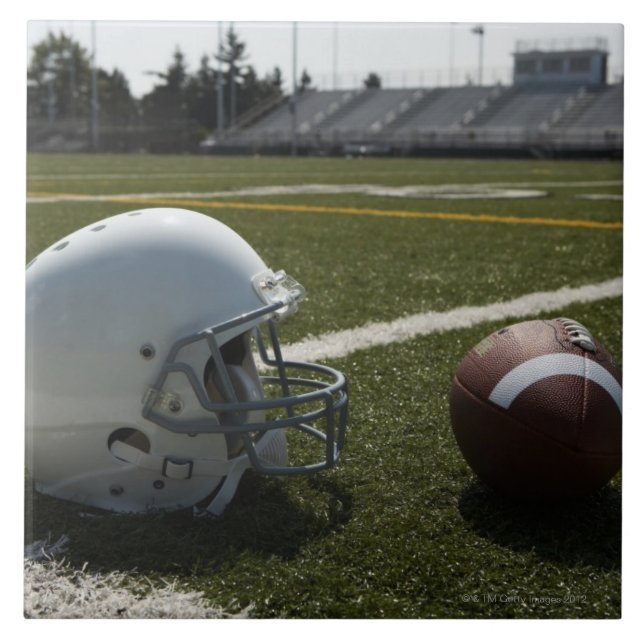 Football and football helmet on football field ceramic tile (Front)