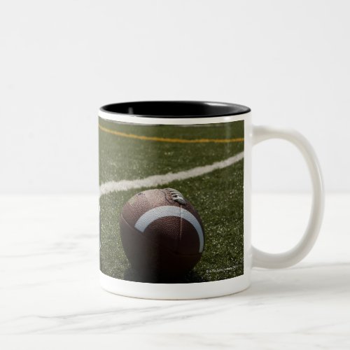 Football and football helmet on football field Two_Tone coffee mug