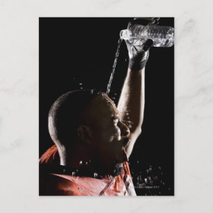 Football player cooling off with water postcard