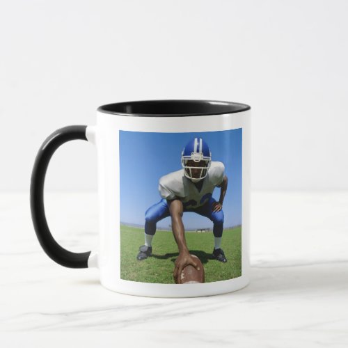 football player playing on a football field mug