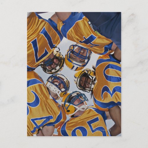 Football players in huddle postcard