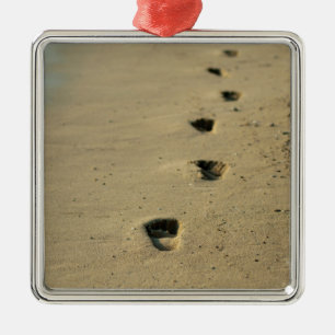 Footprints alongside the sea metal ornament