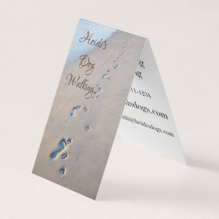 Footprints and dog paw prints in the sand business card