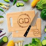 Foral frame and initials wedding Charcuterie Engraved Cutting Board<br><div class="desc">Elegant and charming, this Floral Frame and Initials Wedding Charcuterie Cutting Board is a stunning addition to any wedding celebration. Featuring a beautifully designed round frame adorned with stylized flowers and leaves, this cutting board is not only practical but also serves as a lovely keepsake for the couple. The initials...</div>