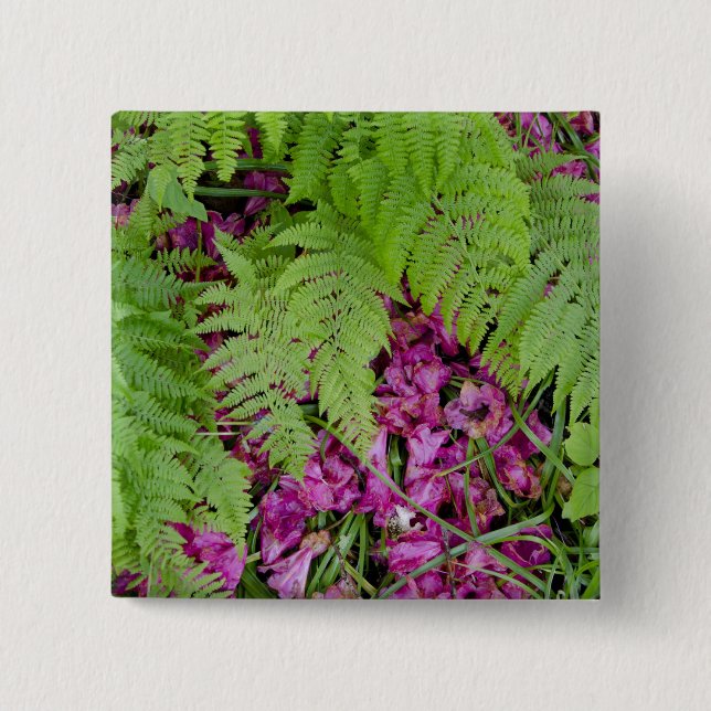 Forest ferns with pink flower petals on ground button (Front)