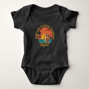 Forever Chasing Sunsets Bigfoot Surfing Black Baby Bodysuit