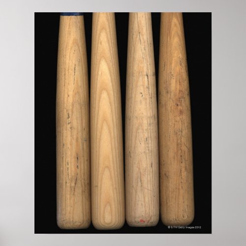 Four old baseball bats on black background poster