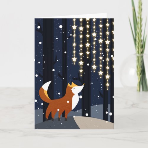 Fox and strings of star lights in the snowy forest holiday card