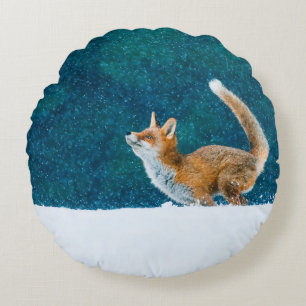Fox in snowfall. Red fox, Vulpes vulpes, jumping i Round Pillow