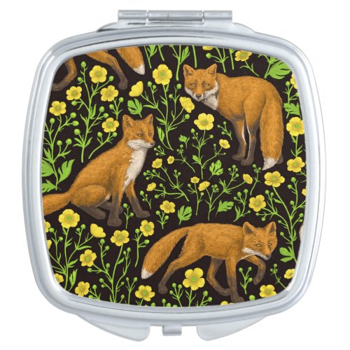 Foxes and buttercups on black compact mirror