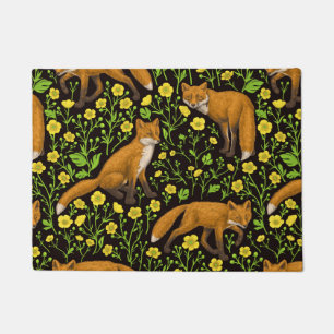 Foxes and buttercups on black doormat