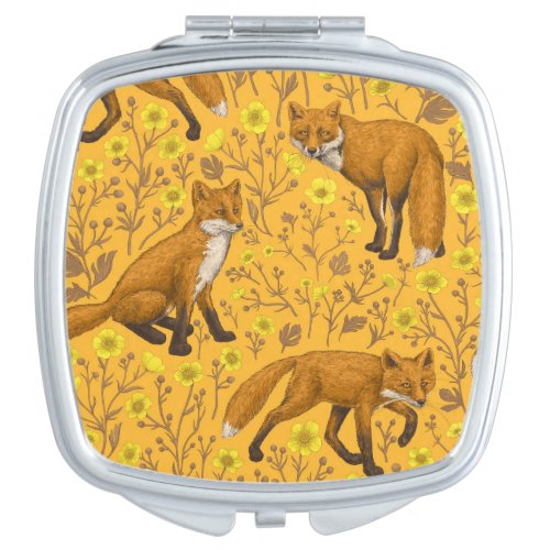 Foxes and buttercups on orange compact mirror