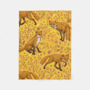 Foxes and buttercups on orange fleece blanket