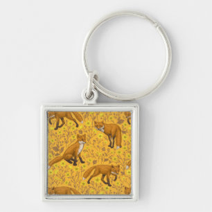 Foxes and buttercups on orange keychain