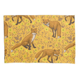 Foxes and buttercups on orange pillow case