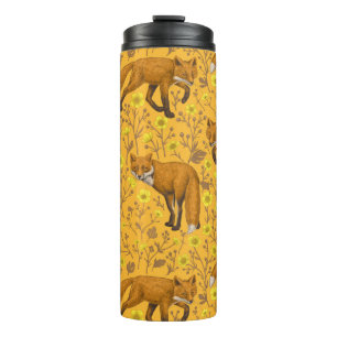 Foxes and buttercups on orange thermal tumbler
