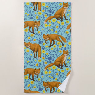 Foxes and buttercups on pool blue beach towel