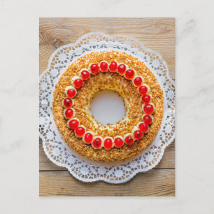 Frankfurt crown cake with cherries on rustic wood postcard