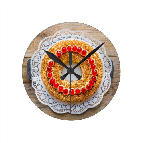 Frankfurt crown cake with cherries on rustic wood round clocks