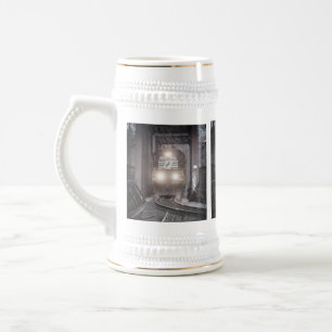 Freight train crossing a bridge beer stein
