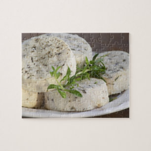 French goat cheese - chevre - with herbs on a jigsaw puzzle
