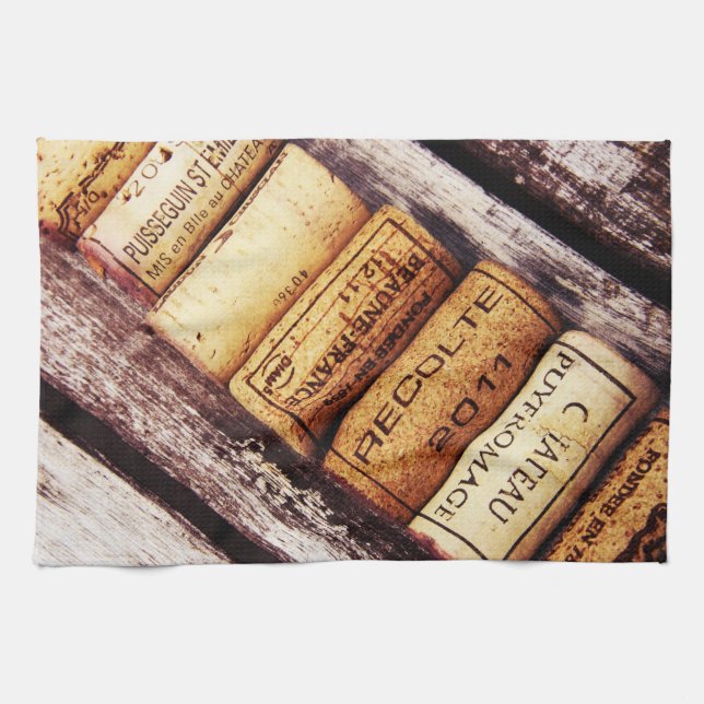 french wine bottle corks on rustic wooden texture kitchen towel (Horizontal)