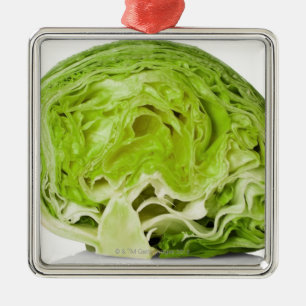 Fresh iceberg lettuce cut in half, on white metal ornament