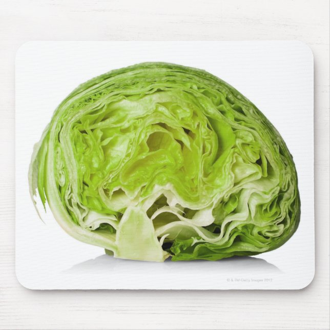Fresh iceberg lettuce cut in half, on white mouse pad (Front)