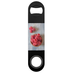 Fresh raspberries in a bowl speed bottle opener