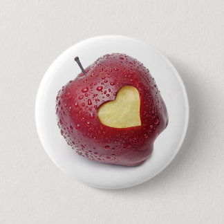 Fresh red apple with a heart shaped symbol pinback button