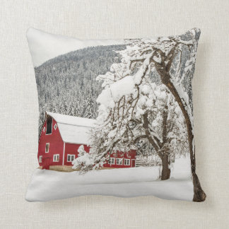 Fresh snow on red barn throw pillow