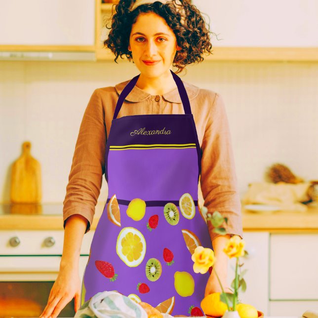 Freshful Summer Fruits Personalizable Apron (A woman in a kitchen wearing a beautiful purple apron decorated with lemons, kiwis, strawberries)