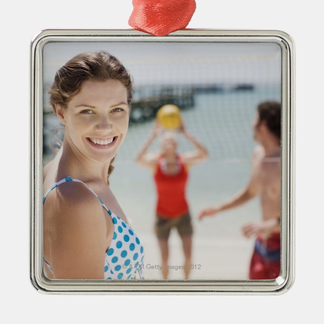 Friends playing volleyball at beach metal ornament (Front)