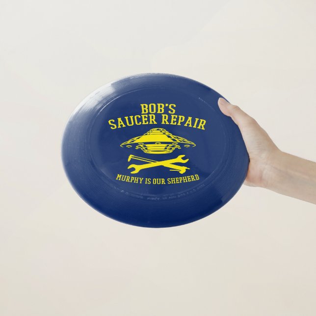 frisbee with yellow Bob's Saucer Repair logo (In Hand)