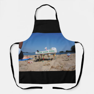Fubby's stealing a pizza on the beach. apron