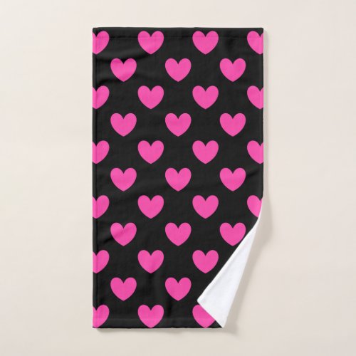 Fuchsia pink polka hearts on black hand towel 