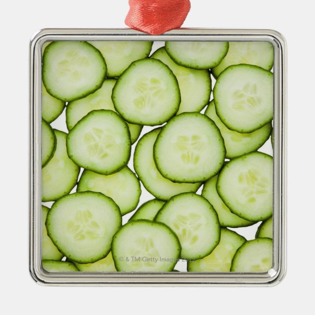 Full frame of sliced cucumber, on white metal ornament (Front)