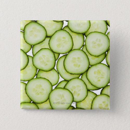Full frame of sliced cucumber on white pinback button
