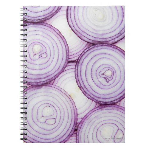 Full frame of sliced red onion on white notebook
