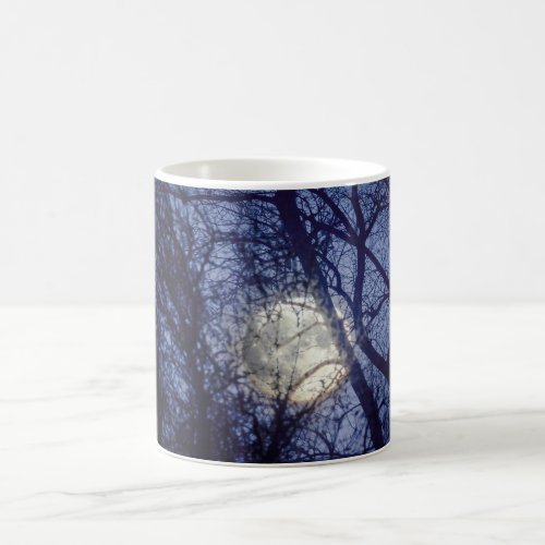 Full moon through bare winter trees coffee mug