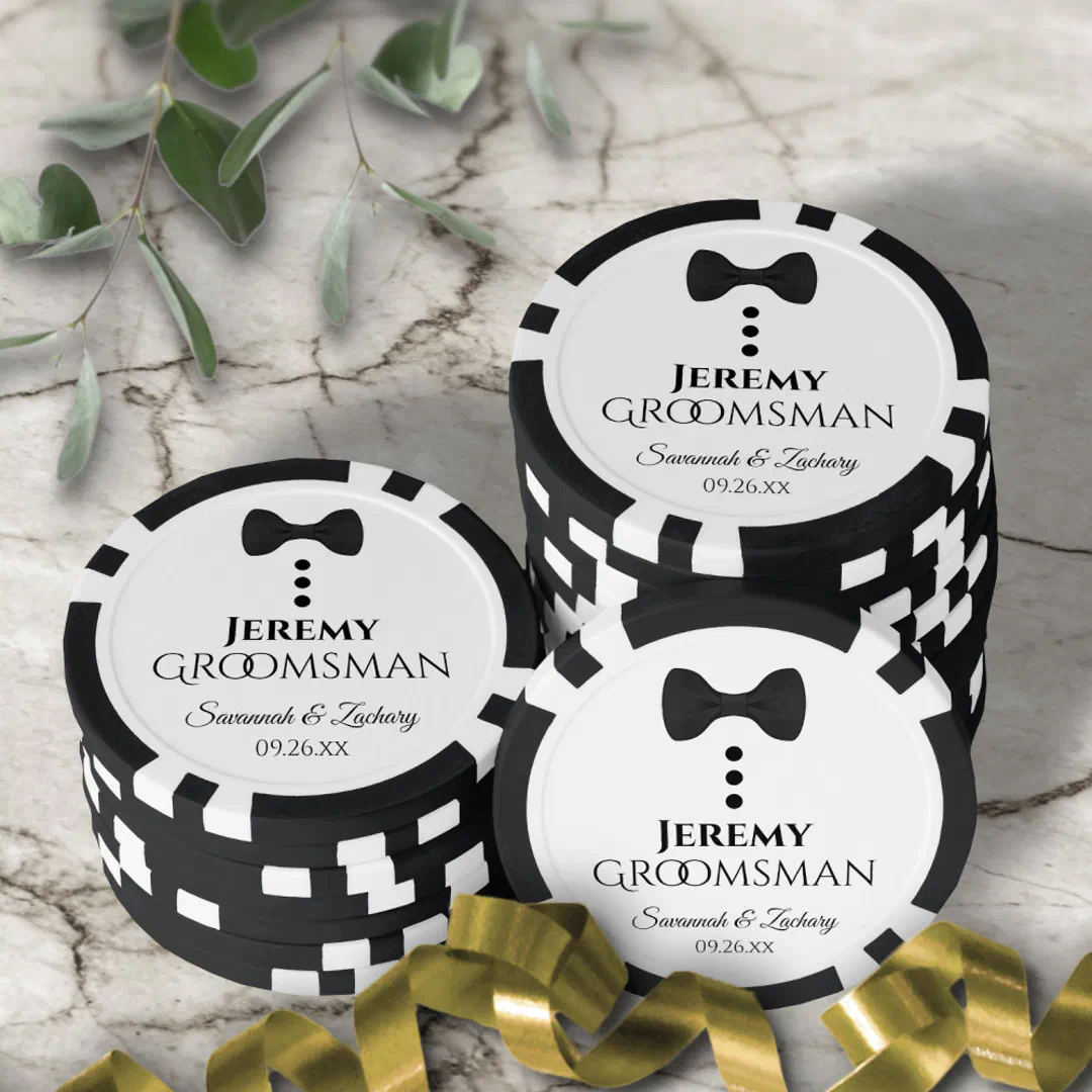 Custom groomsman poker chips featuring a black bow tie and tuxedo button design on a marble background.