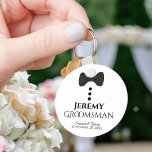 Fun Black Tie Tuxedo Groomsman Wedding Favor Keychain<br><div class="desc">This cute keychain is designed as a gift for your groomsmen. Features a fun design with a black bow tie and buttons on a white background. The text reads "Groomsman" with a place for his name, along with the names of the wedding couple & the date. Great way to thank...</div>