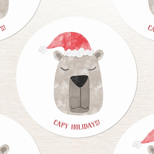 Fun Capybara Santa Hat Christmas Classic Round Sticker (Fun capybara in a Santa hat with custom text Christmas sticker for the winter holidays.)