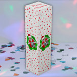 Fun Christmas Skeleton in Spatter Shape Red Stars Wine Box<br><div class="desc">This gift wine box has a fun skeleton holding shiny ornaments up to his eyes in a bright red and green splatter shape with a scattering of little red stars on a white textured background.   Customise your text on the top flap with the template.</div>