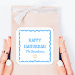 Fun Modern Wavy Border Blue Hanukkah Present Square Sticker<br><div class="desc">Celebrate the holiday season with these Happy Hanukkah stickers, perfect for adding a refined and personalized touch to your festivities. Featuring a festive blue wavy border and customizable family name text, these stickers bring a blend of classic charm and modern style to gift wrapping, party favors, or holiday decor. Ideal...</div>