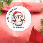 Fun Penguin with Lights Family Name Christmas Classic Round Sticker<br><div class="desc">Create unique personalized Christmas stickers for envelope seals,  favors or gift wraps with a design that says "Merry Christmas" and features a cute penguin in red Santa hat holding Christmas lights. The template makes it easy to type your family name in casual script font.</div>